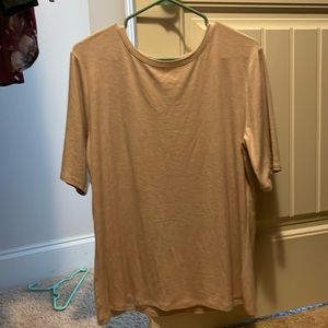 The shirt is a creamy pink color